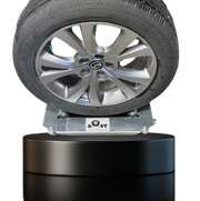 A Wheel Boost tool with a tire mounted on it, designed for changing tires on small to mid-size vehicles.